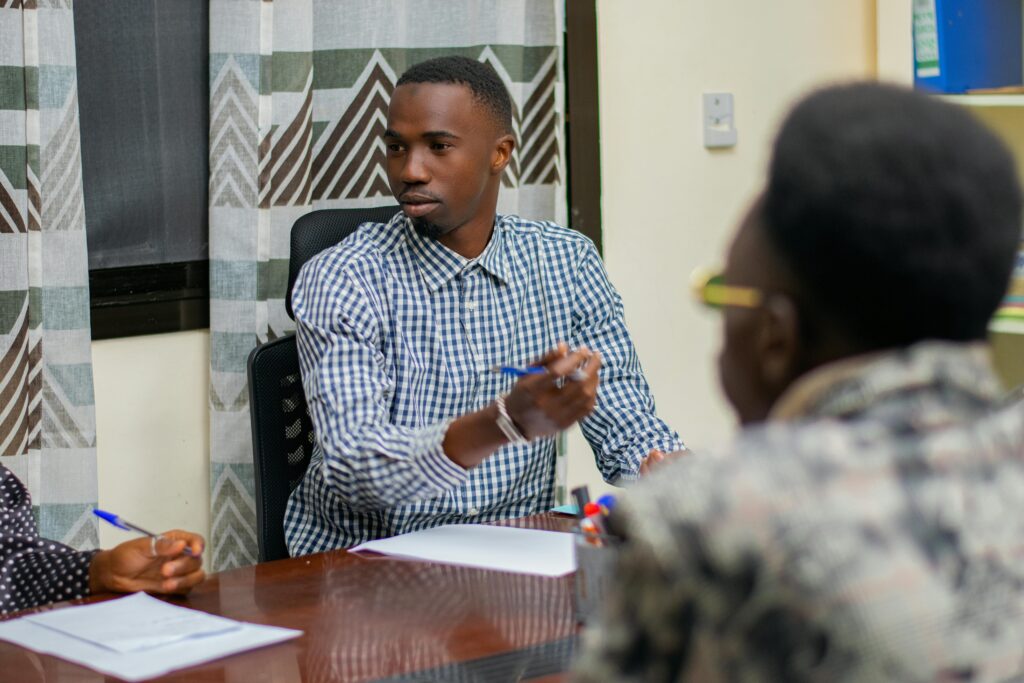 Business professionals engaged in a focused meeting around a conference table.